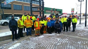Group of police officers, fire fighters and Bonnyvill Victim Services staff posing for a group photo outside